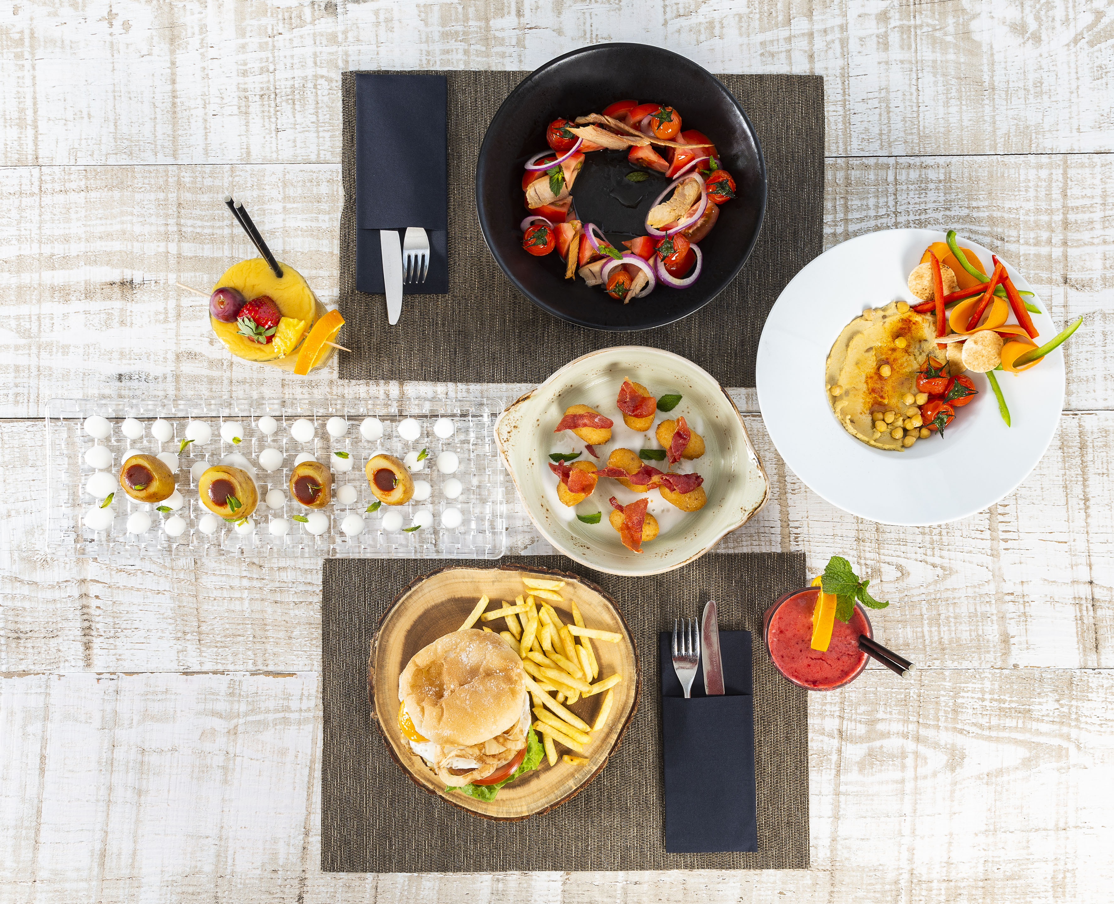 a table with plates of food and drinks