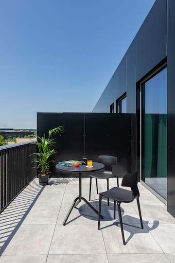 a table and chairs on a balcony
