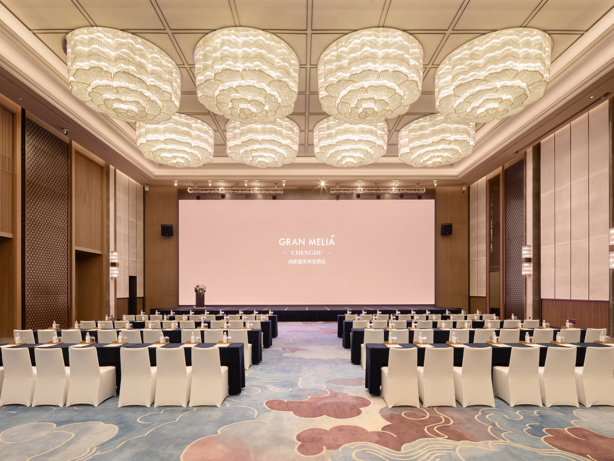 a room with a large screen and chairs