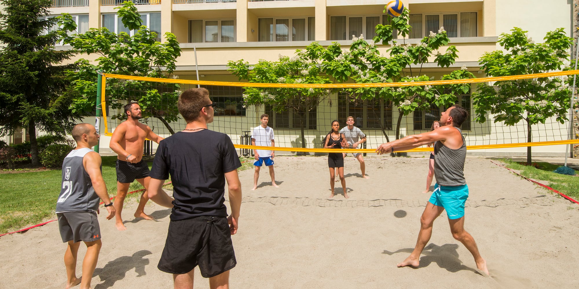 a group of people playing volleyball