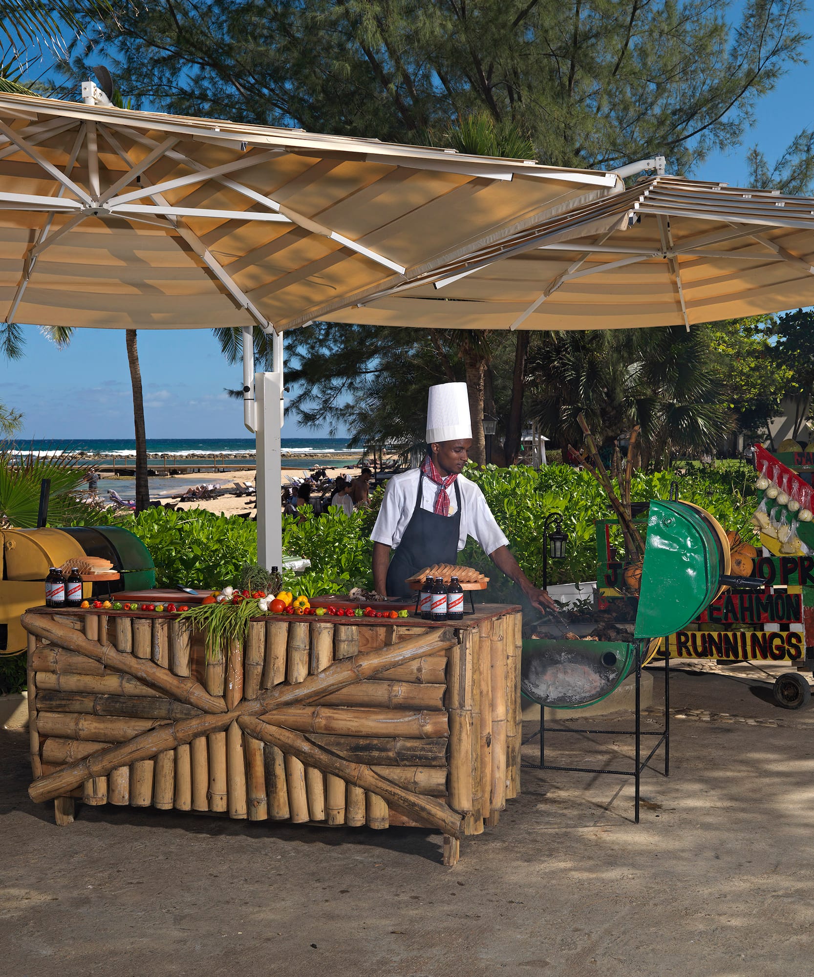 a man cooking food under a canopy