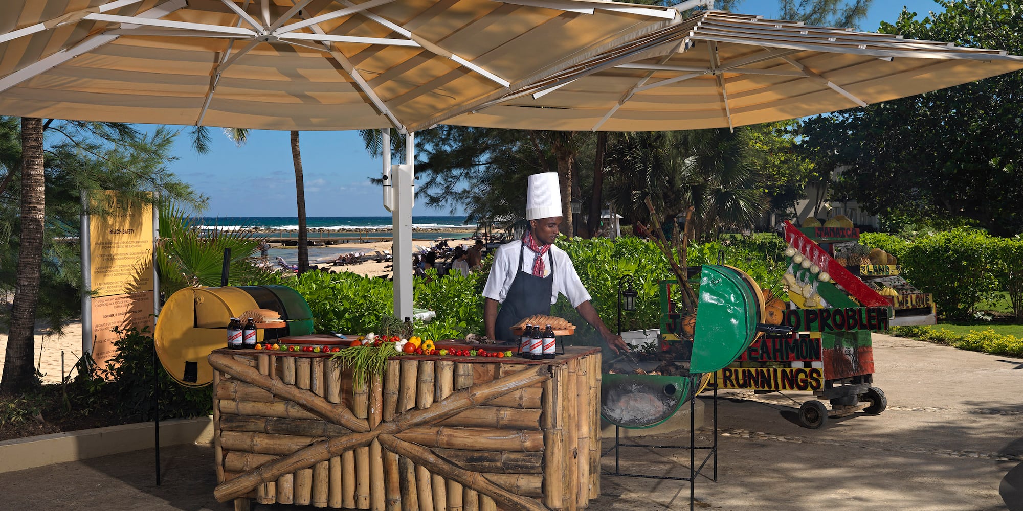 a man cooking food under a canopy