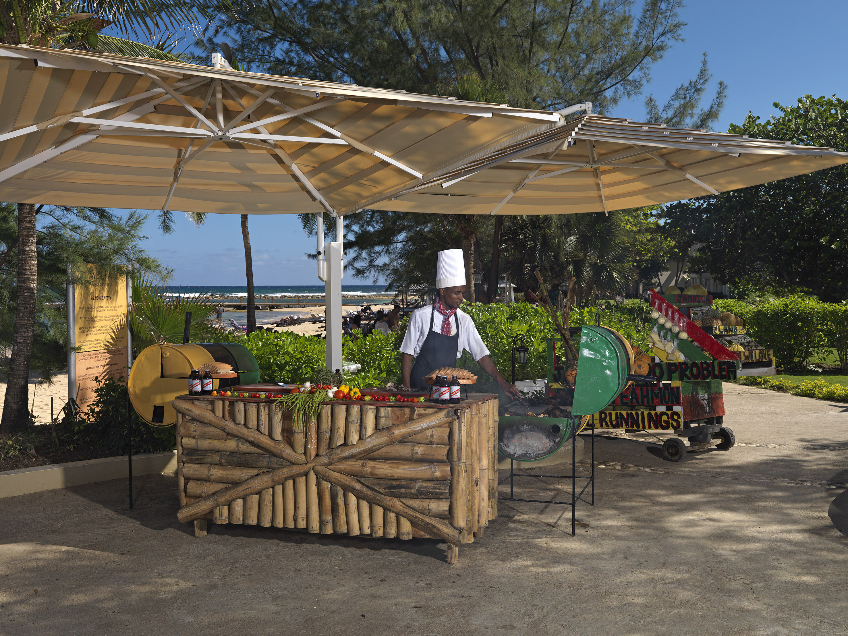 a man cooking food under a canopy