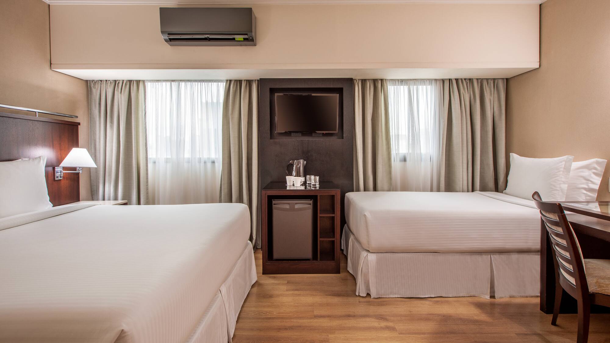 a room with two beds and a television