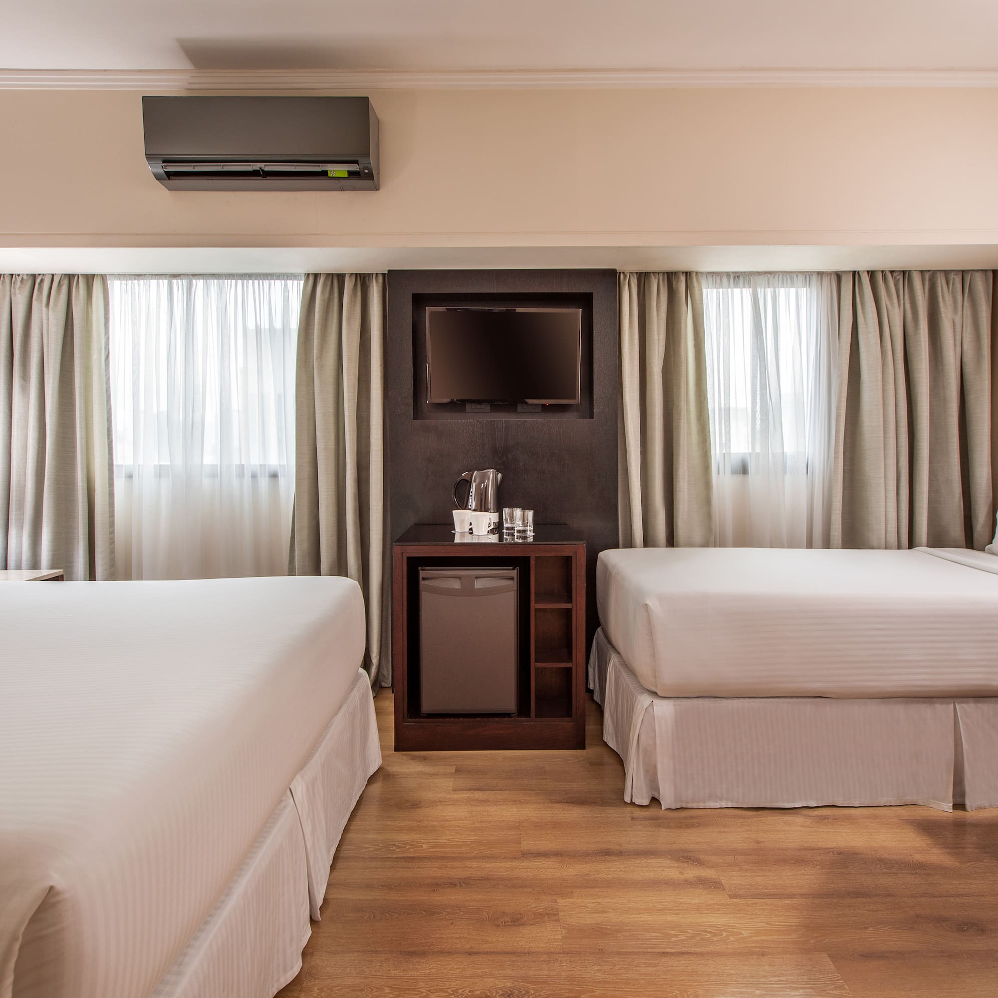 a room with two beds and a television