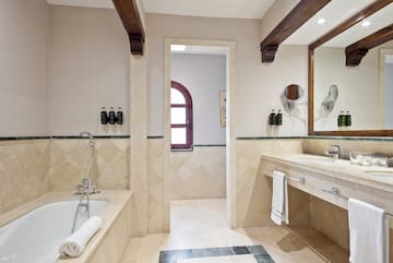 a bathroom with a tub and sink