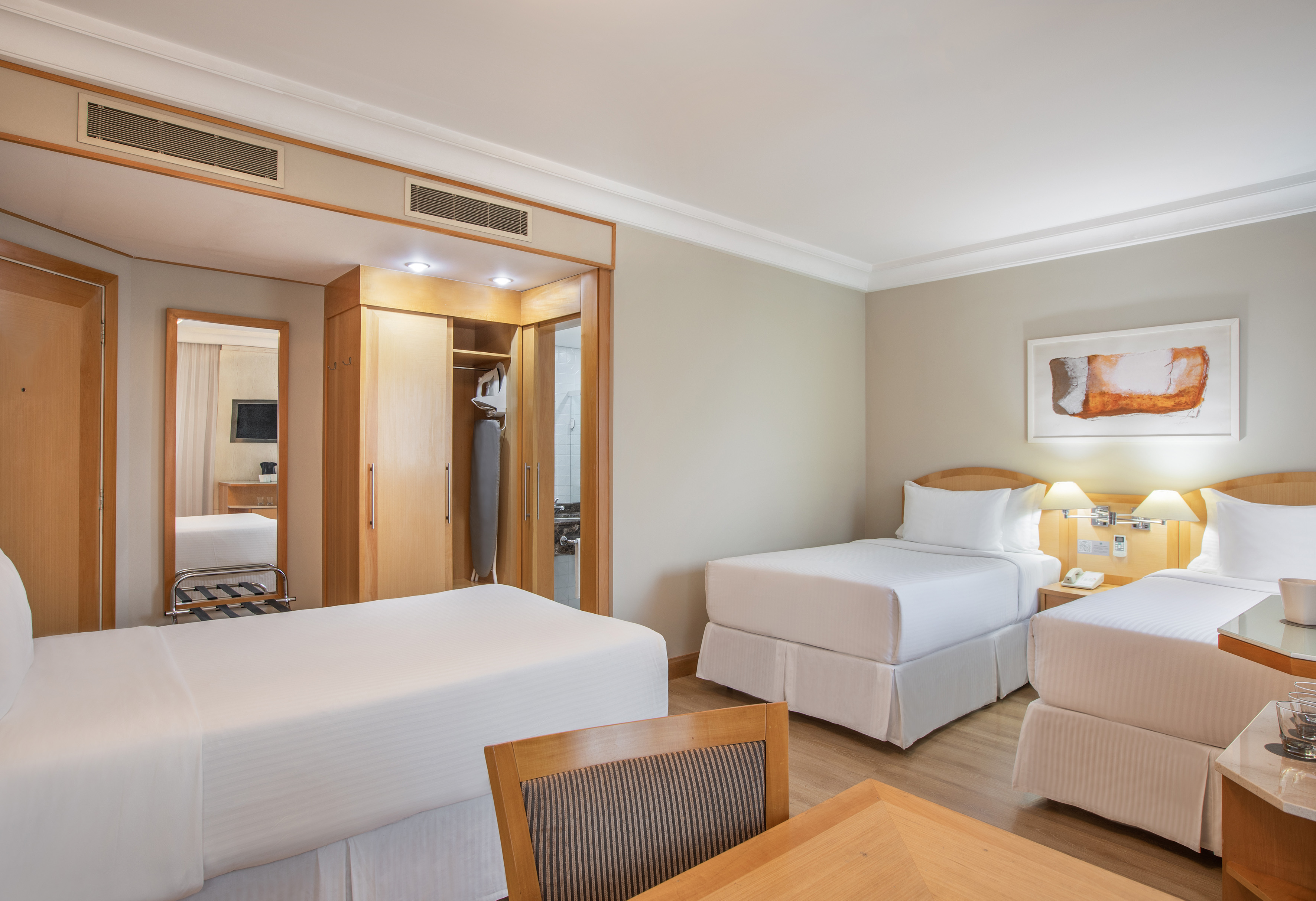 a room with two beds and a mirror