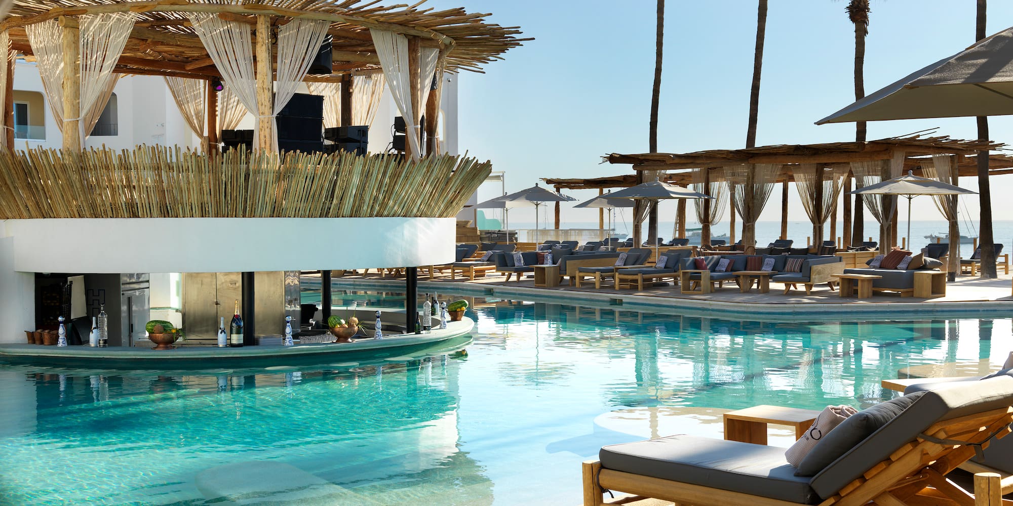 a pool with lounge chairs and a bar