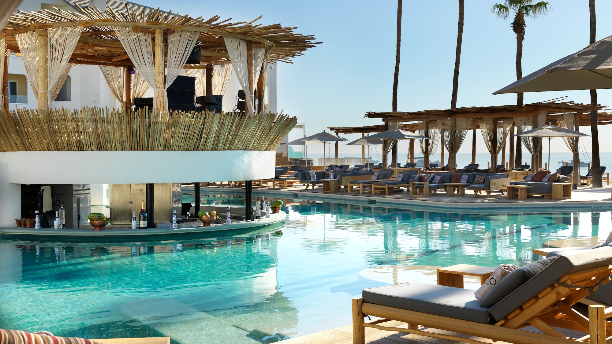 a pool with lounge chairs and a bar