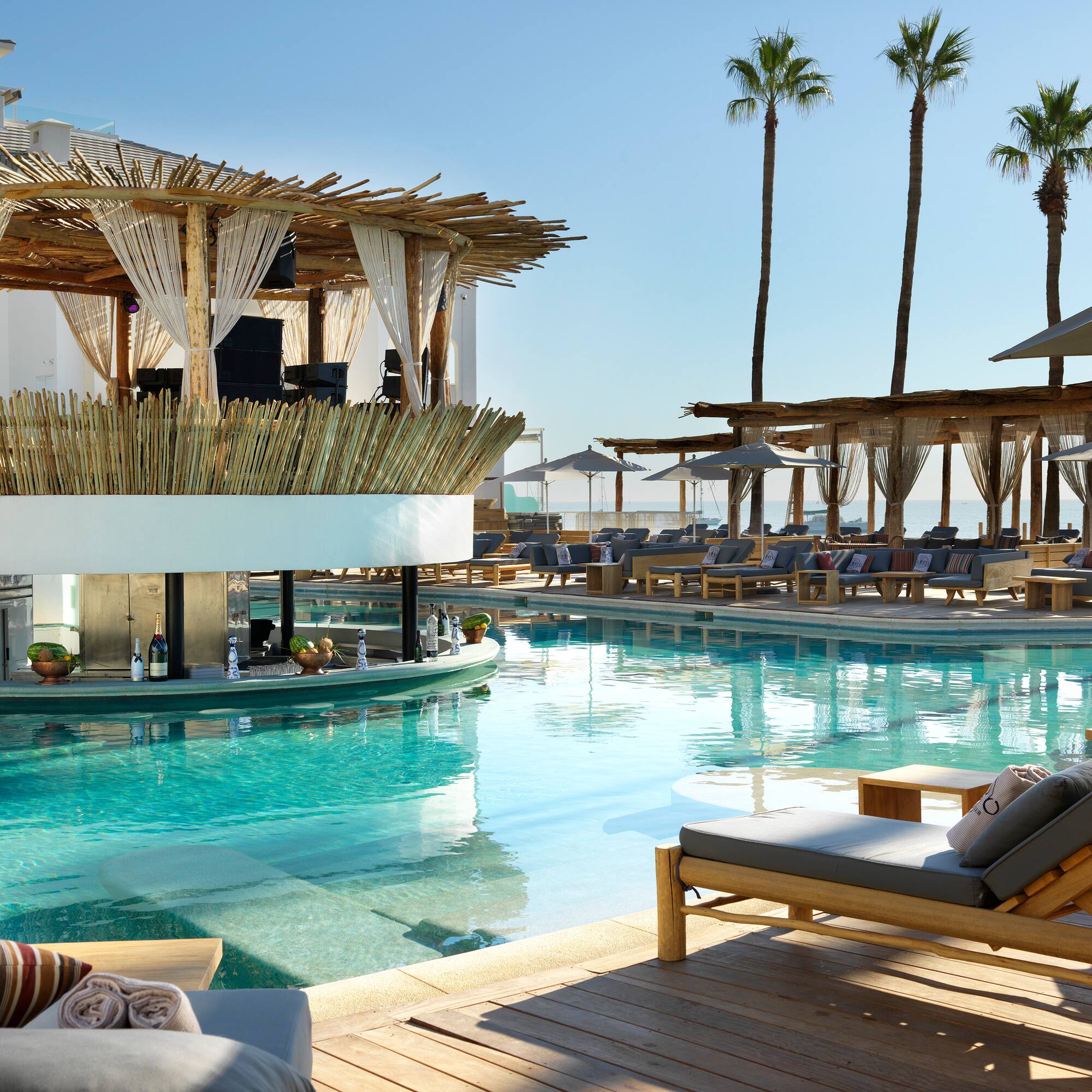 a pool with lounge chairs and a bar