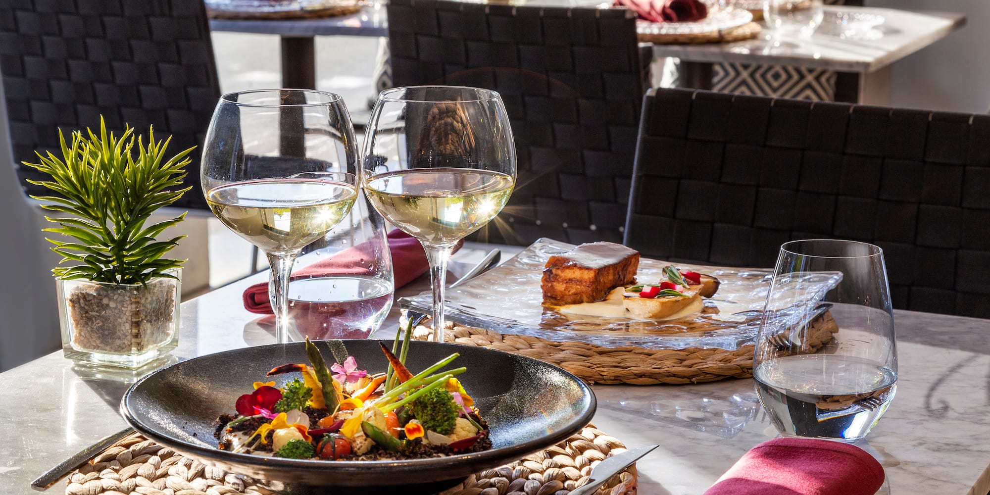 a table with food and wine glasses