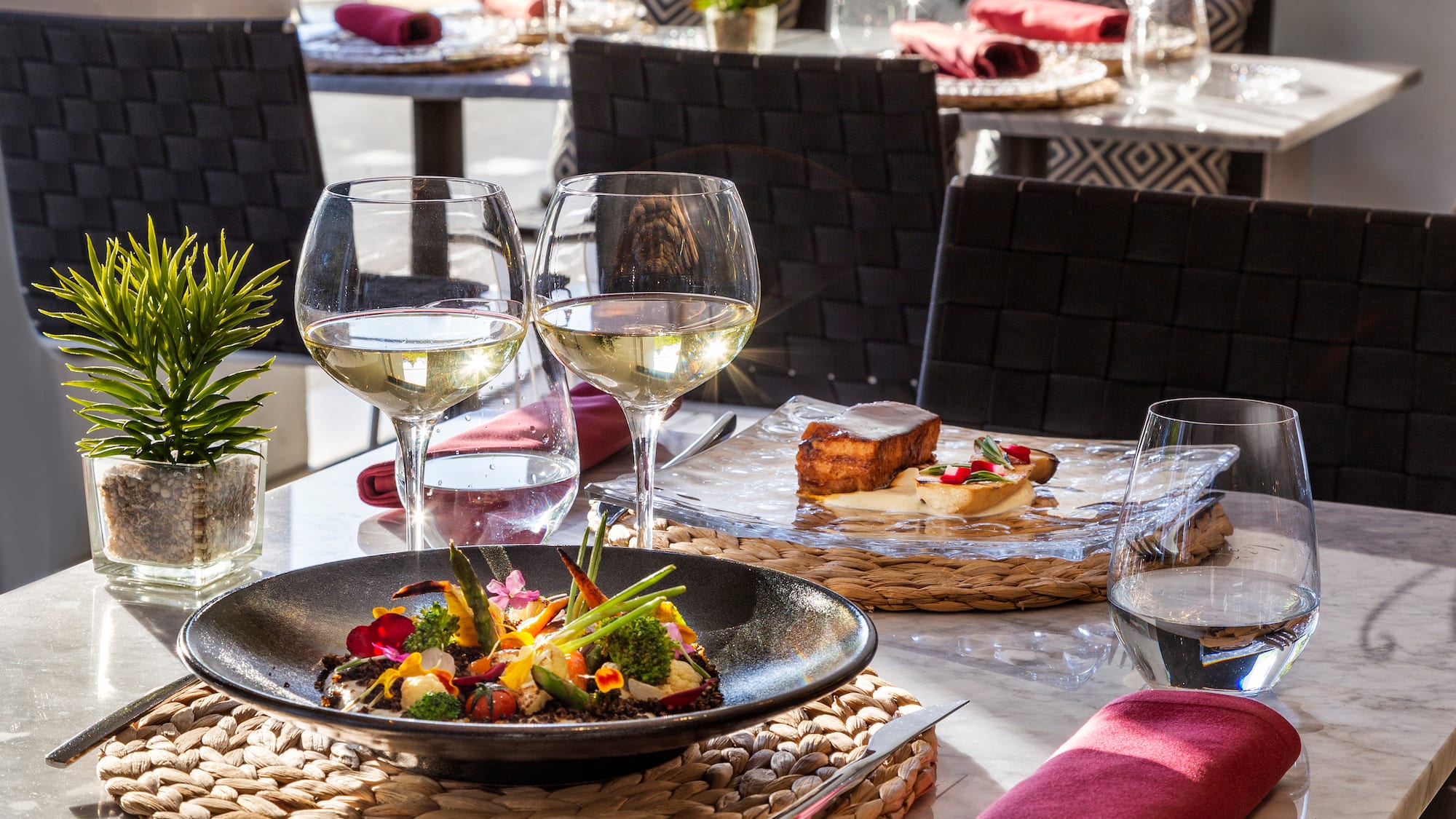 a table with food and wine glasses