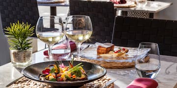 a table with food and wine glasses