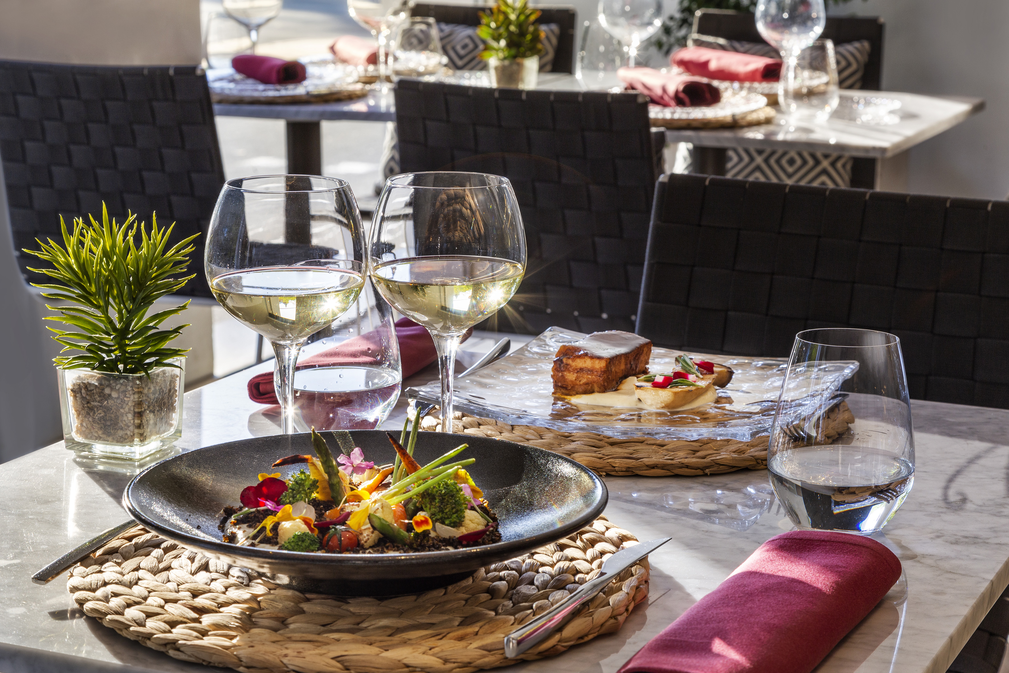 a table with food and wine glasses