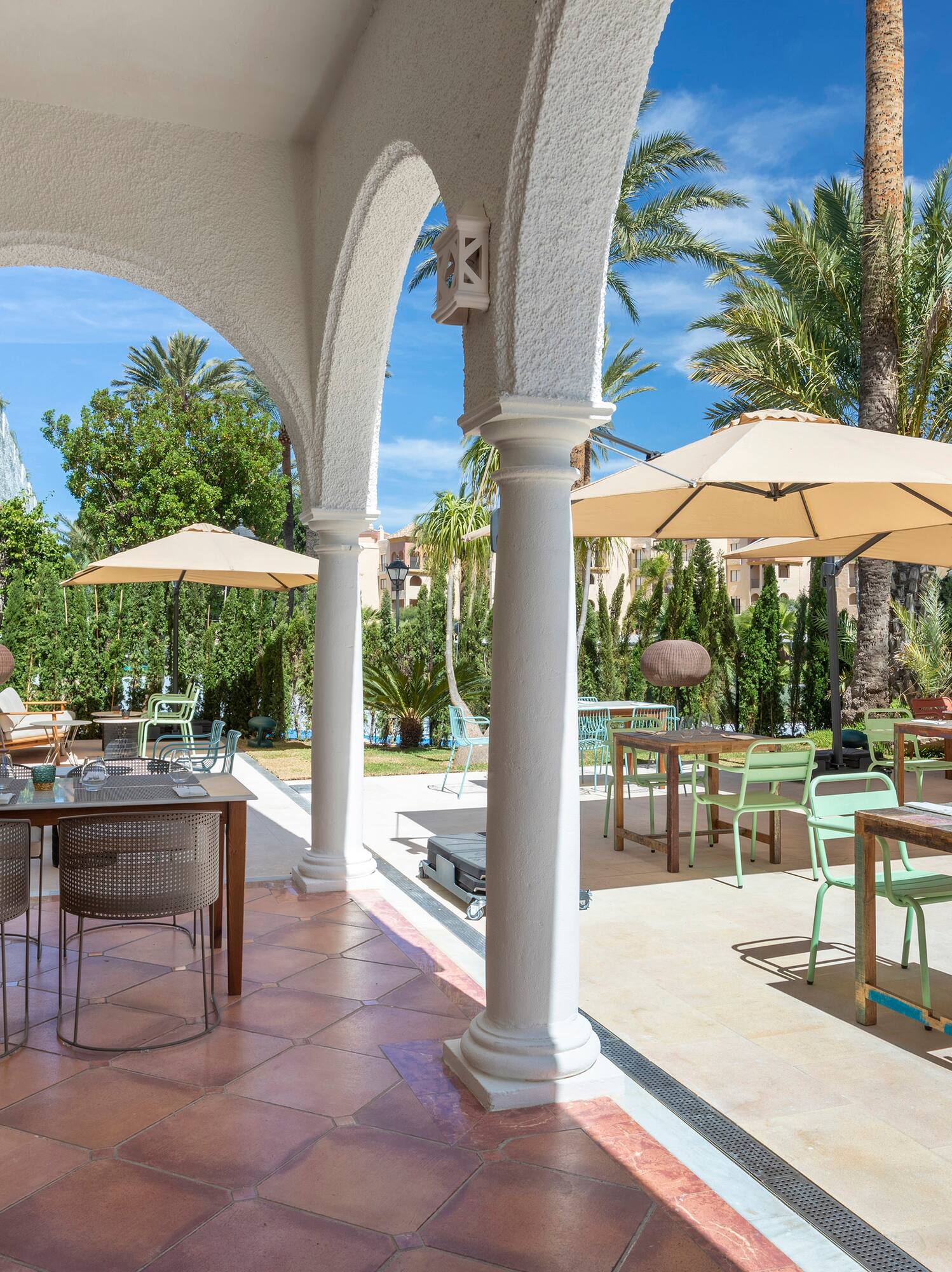 a patio with tables and umbrellas