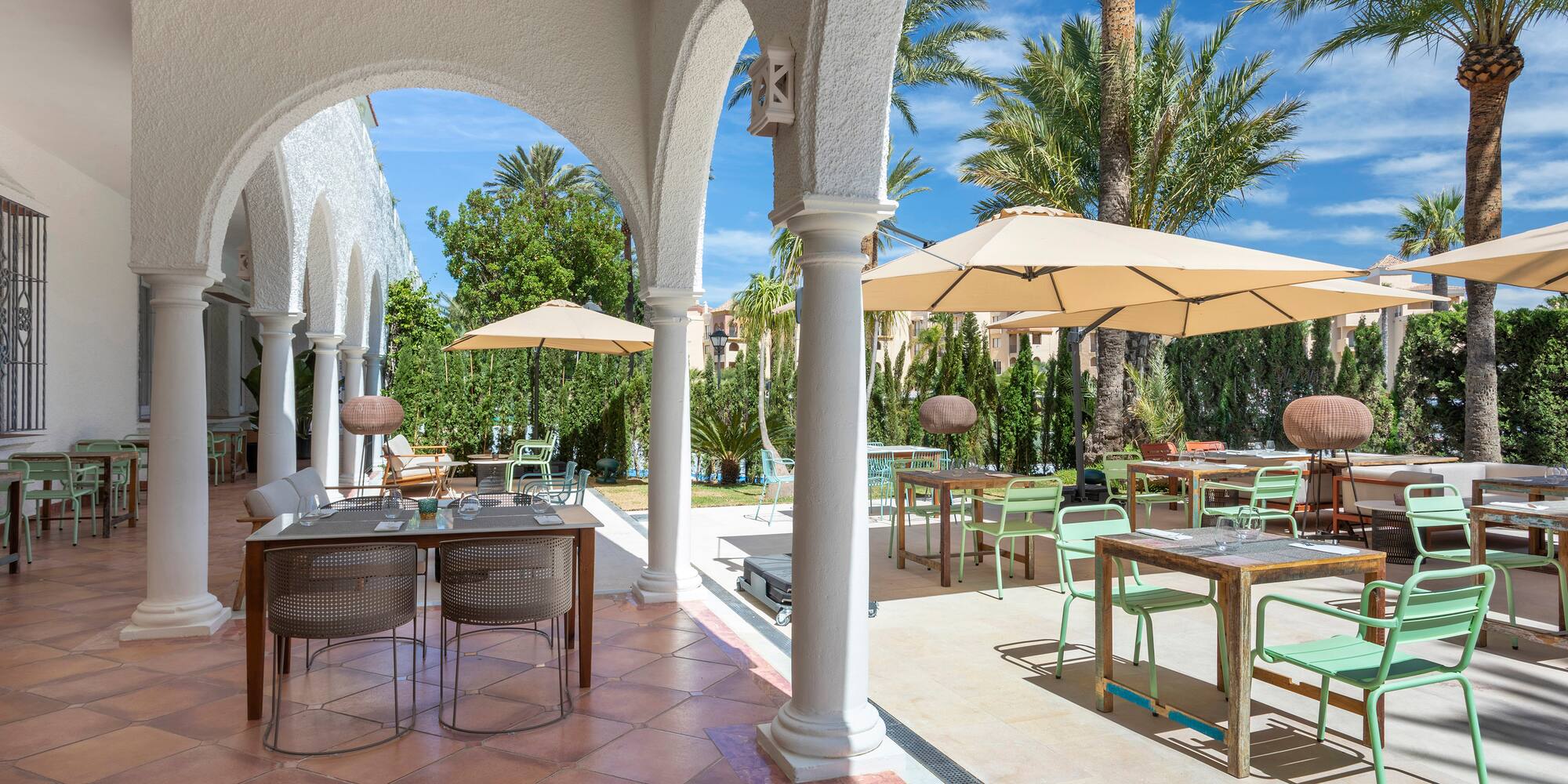 a patio with tables and umbrellas