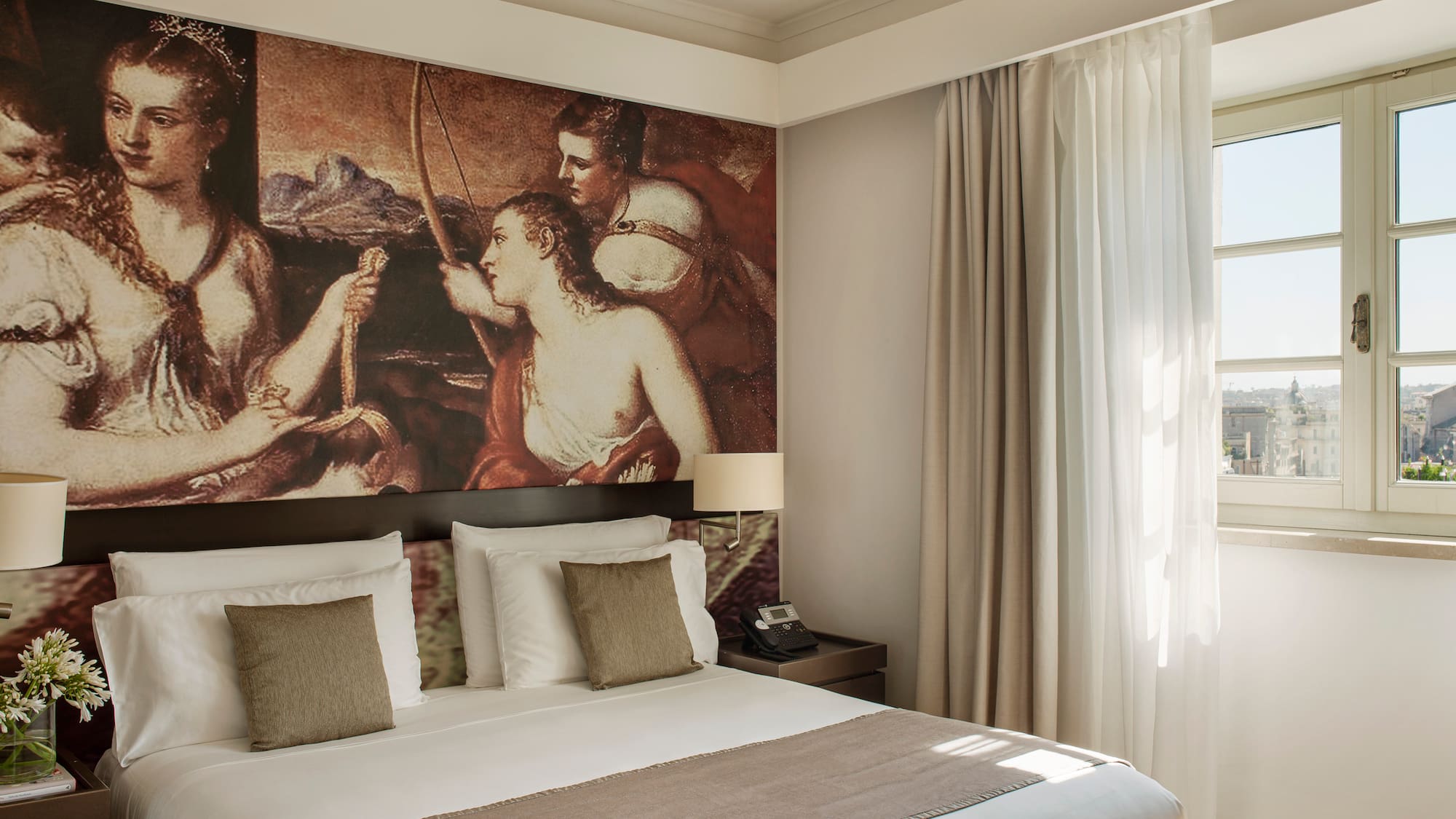 a bed with a large painting above it