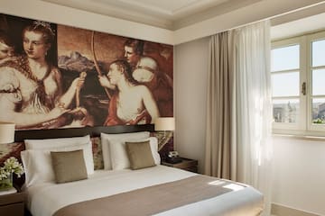 a bed with a large painting above it