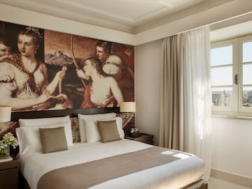 a bed with a large painting above it