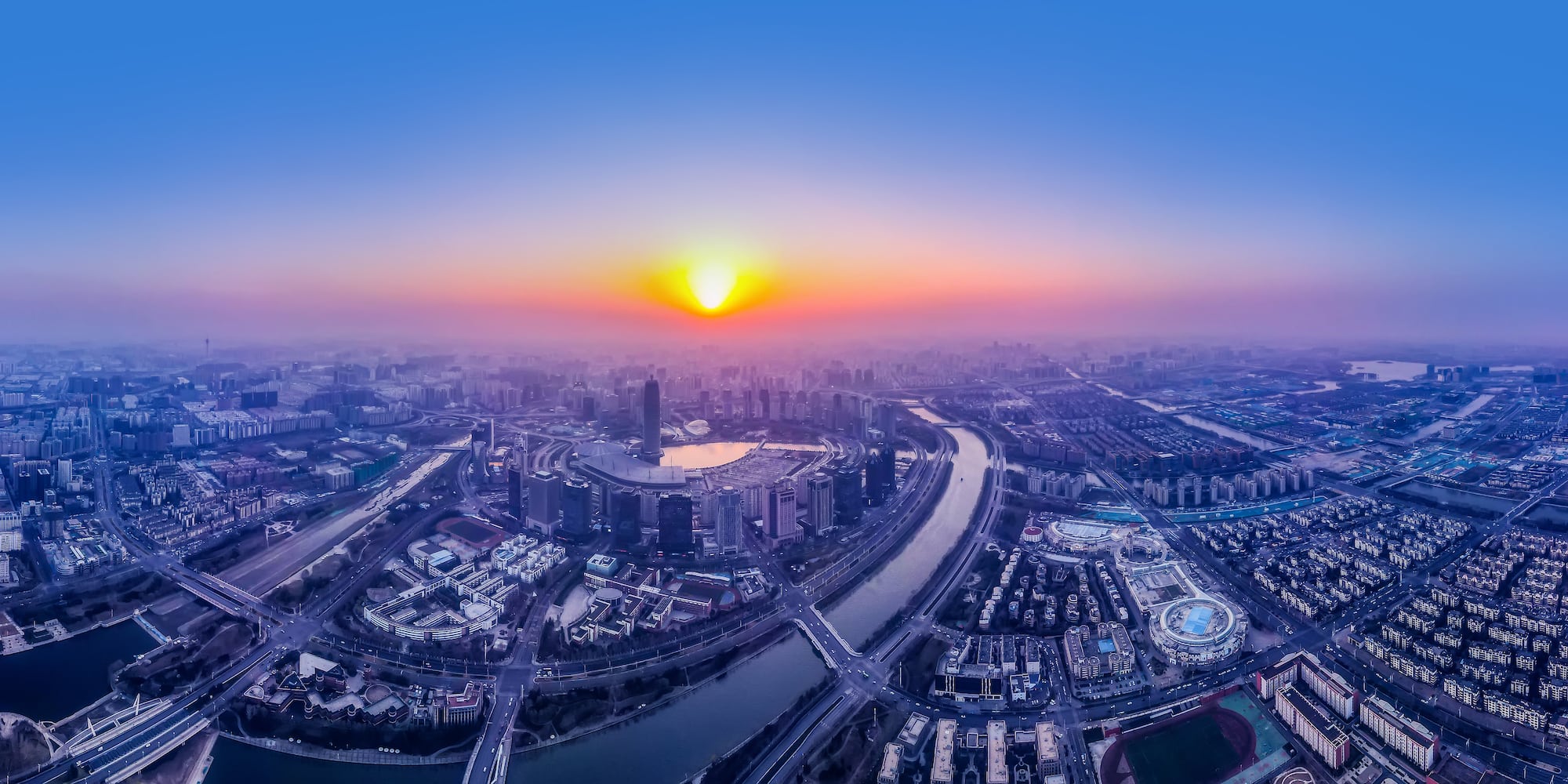 a city with a river and a city in the background