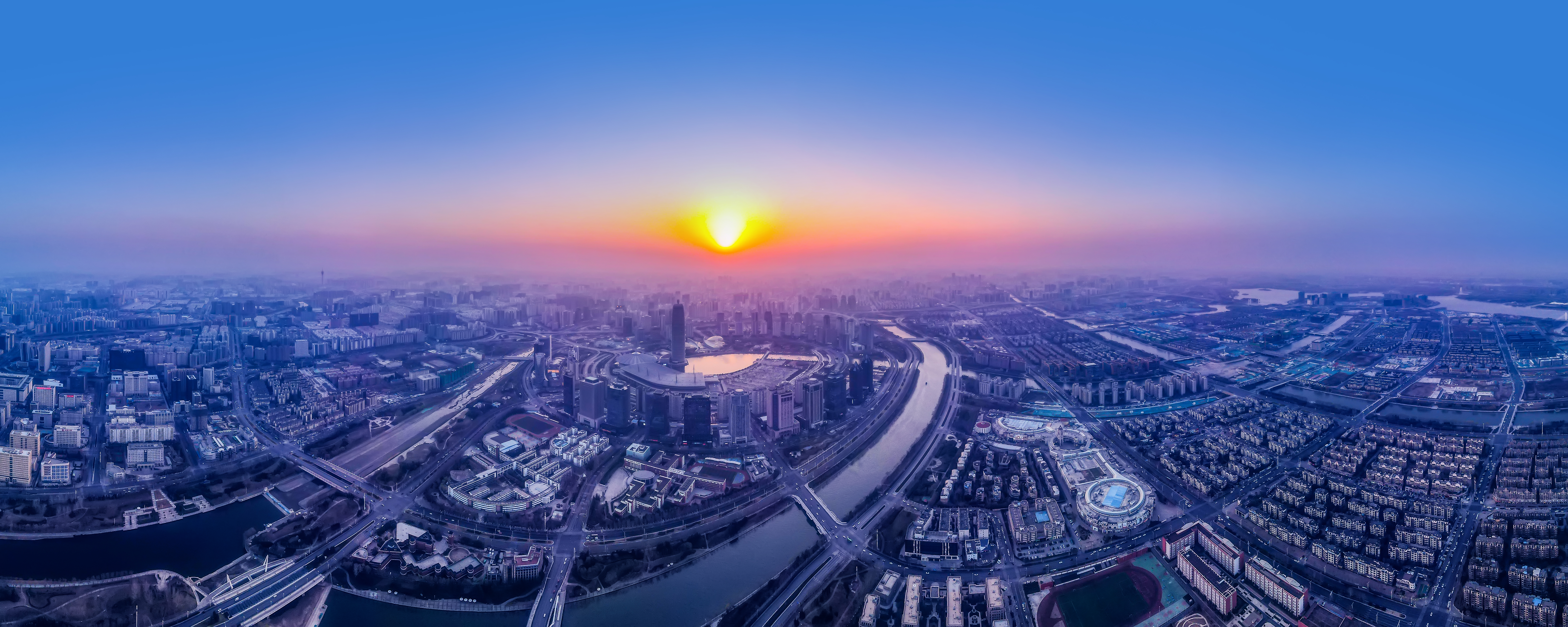 a city with a river and a city in the background