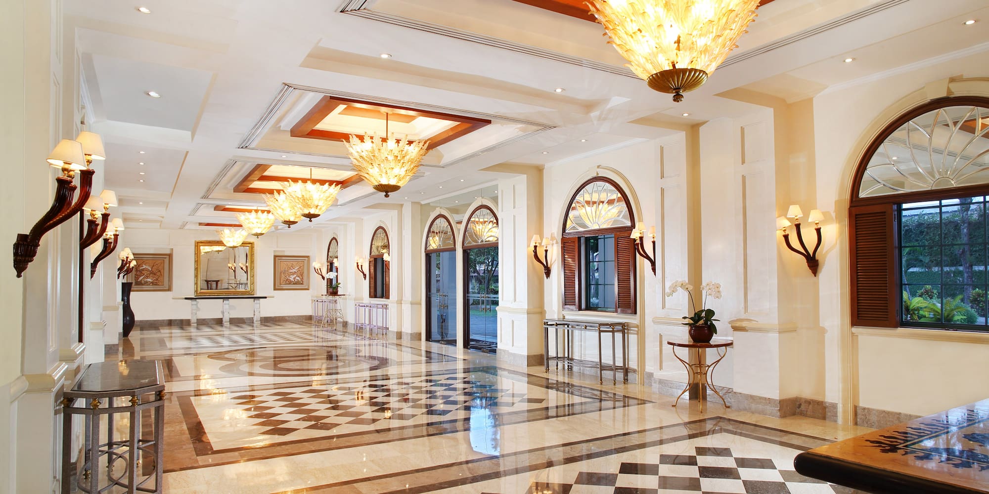 a large hall with chandeliers and checkered floor