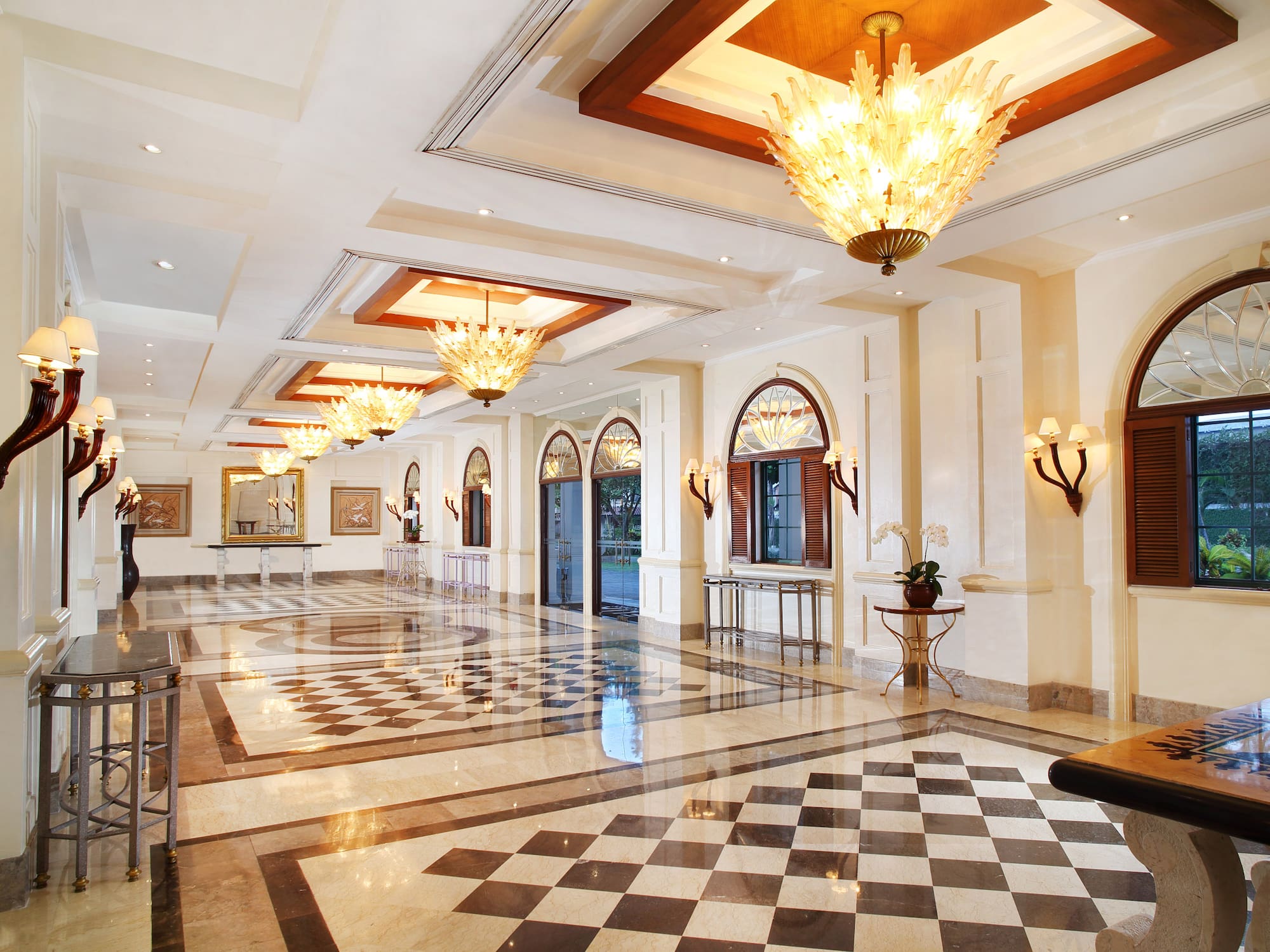 a large hall with chandeliers and checkered floor