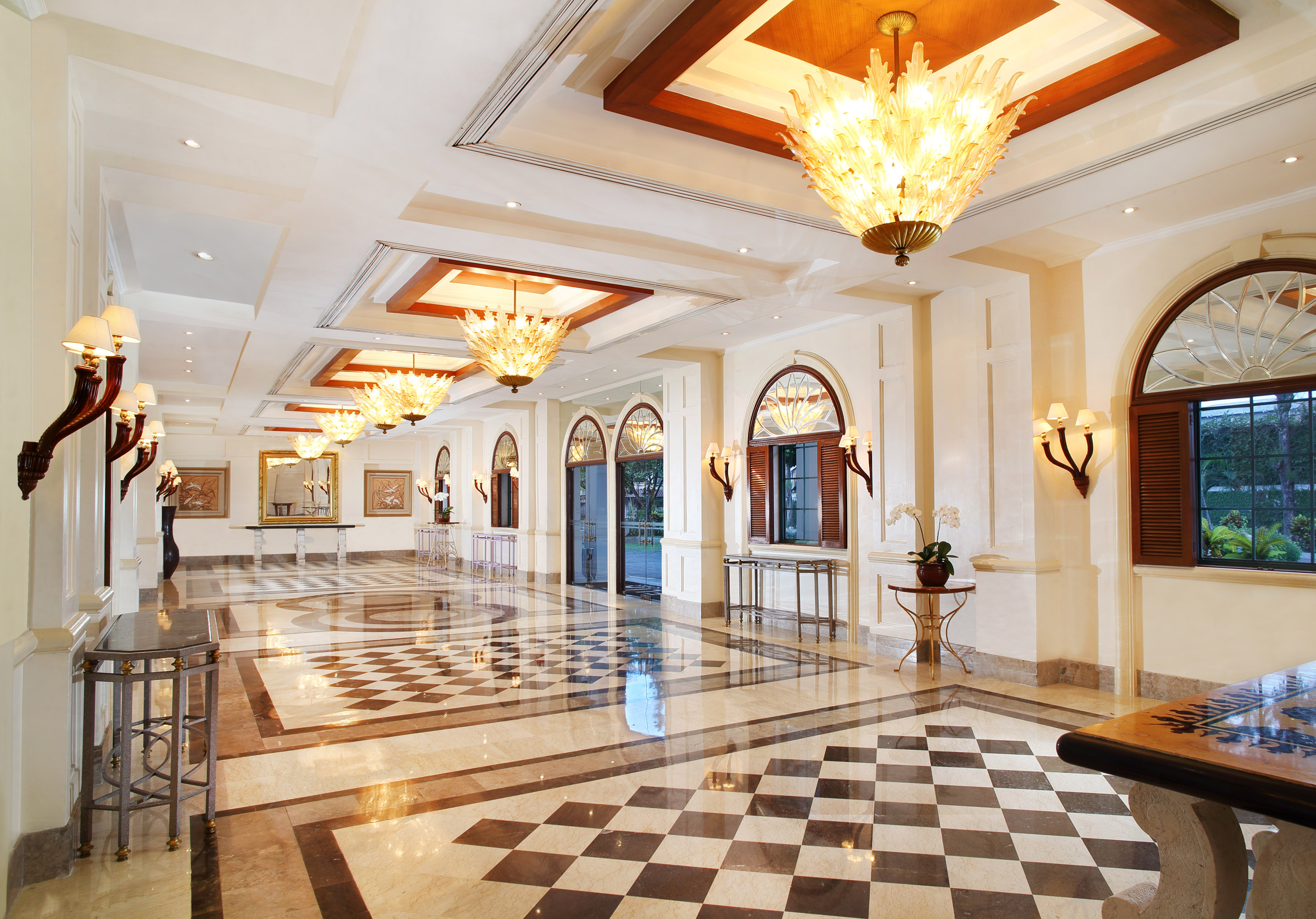 a large hall with chandeliers and checkered floor