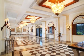 a large hall with chandeliers and checkered floor