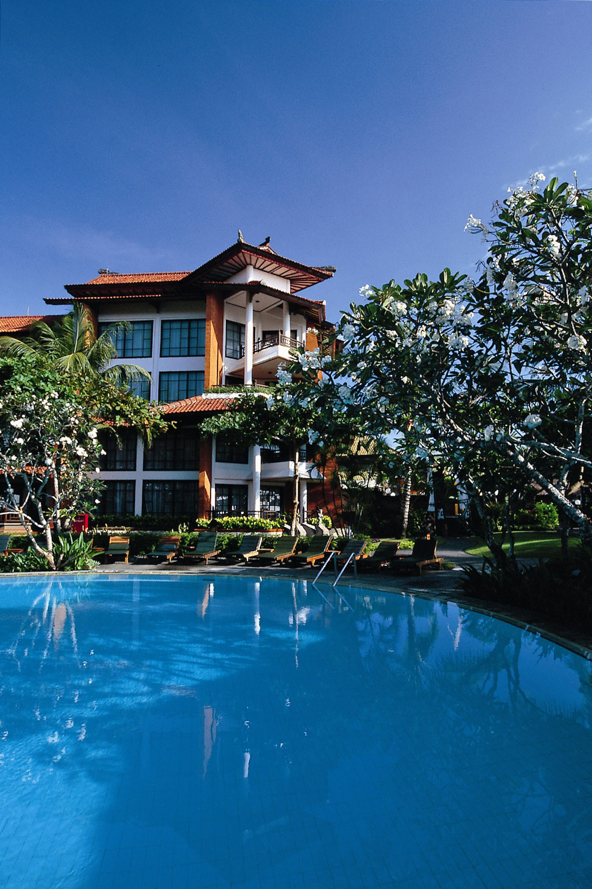a swimming pool in front of a building