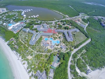 a aerial view of a resort with a pool and a body of water