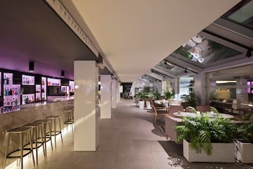 a room with a bar and tables