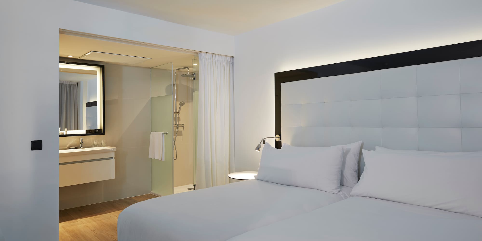 a hotel room with a double bed and a shower