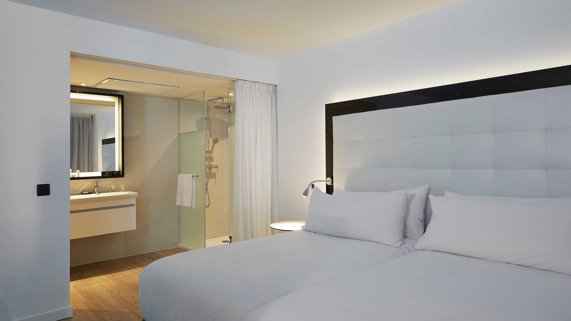 a hotel room with a double bed and a shower