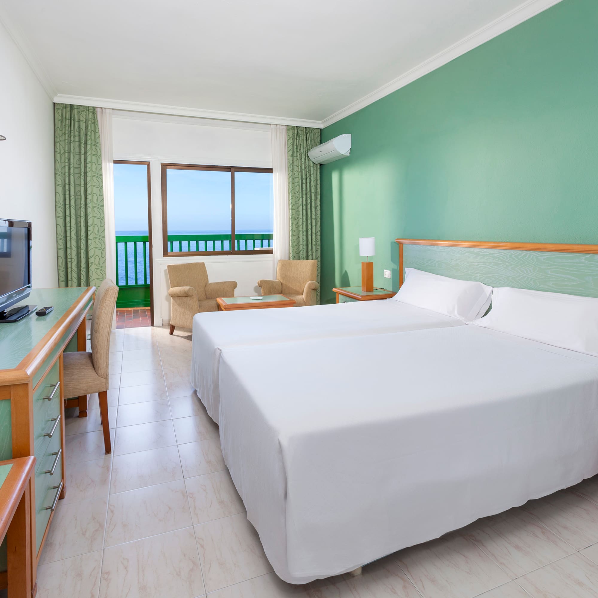 a room with two beds and a desk