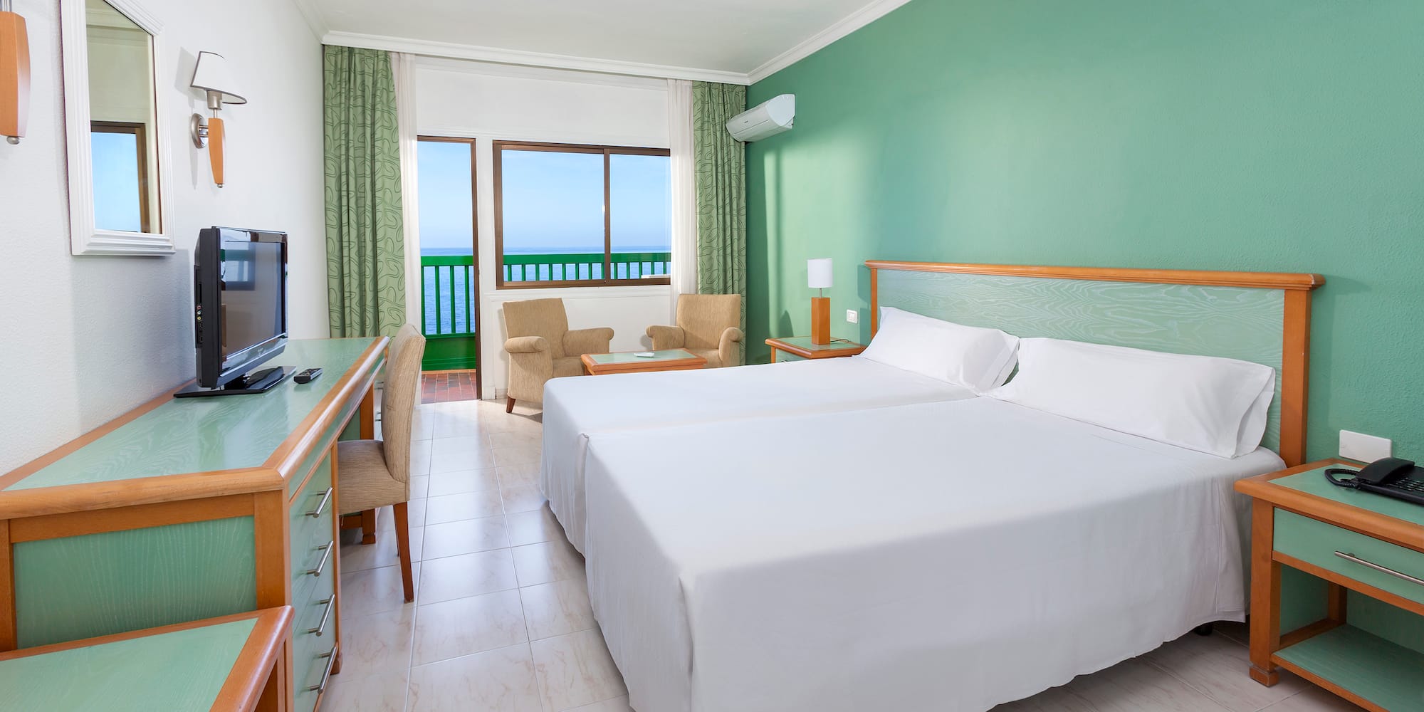 a room with two beds and a desk