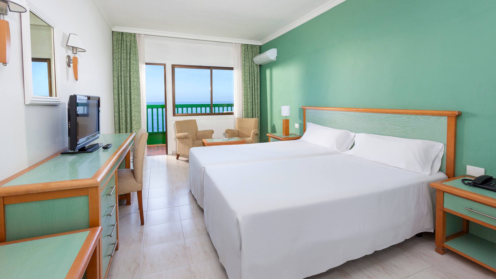 a room with two beds and a desk