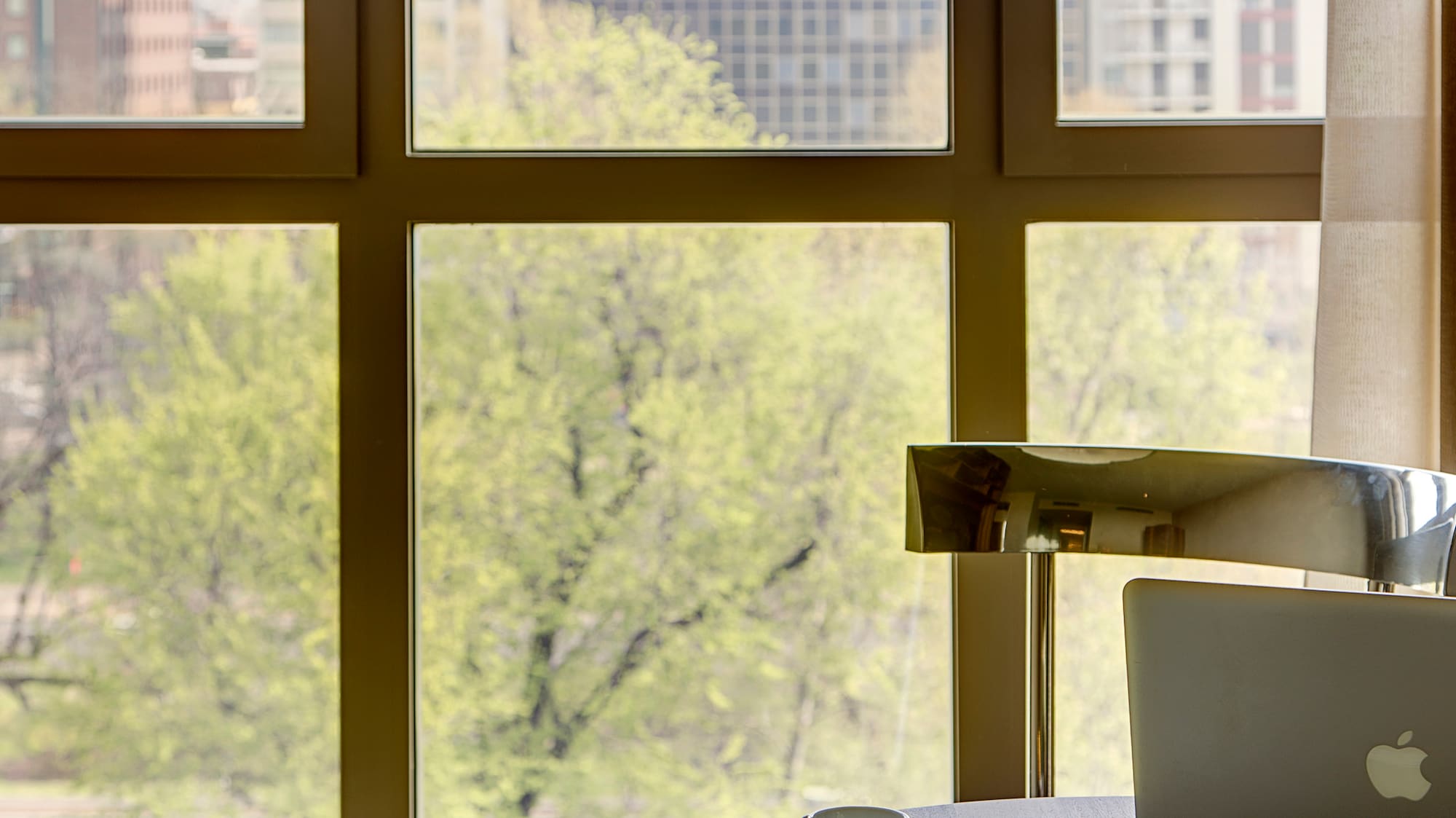 a coffee cup on a table next to a window