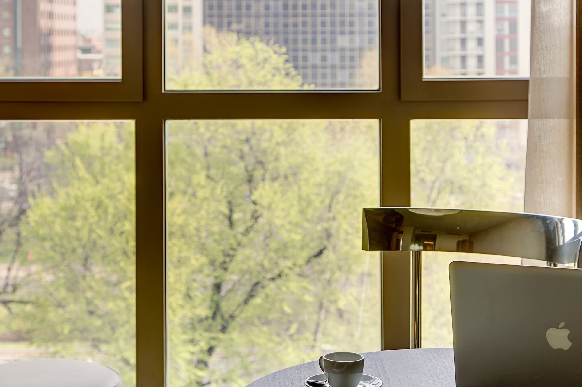 a coffee cup on a table next to a window