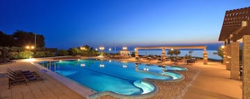 a swimming pool with a gazebo and chairs