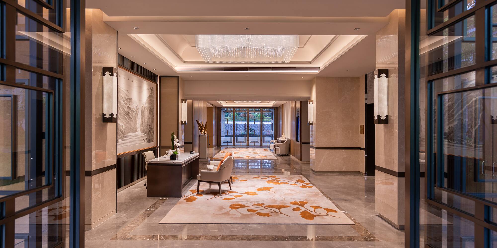 a lobby with a large rug and chairs