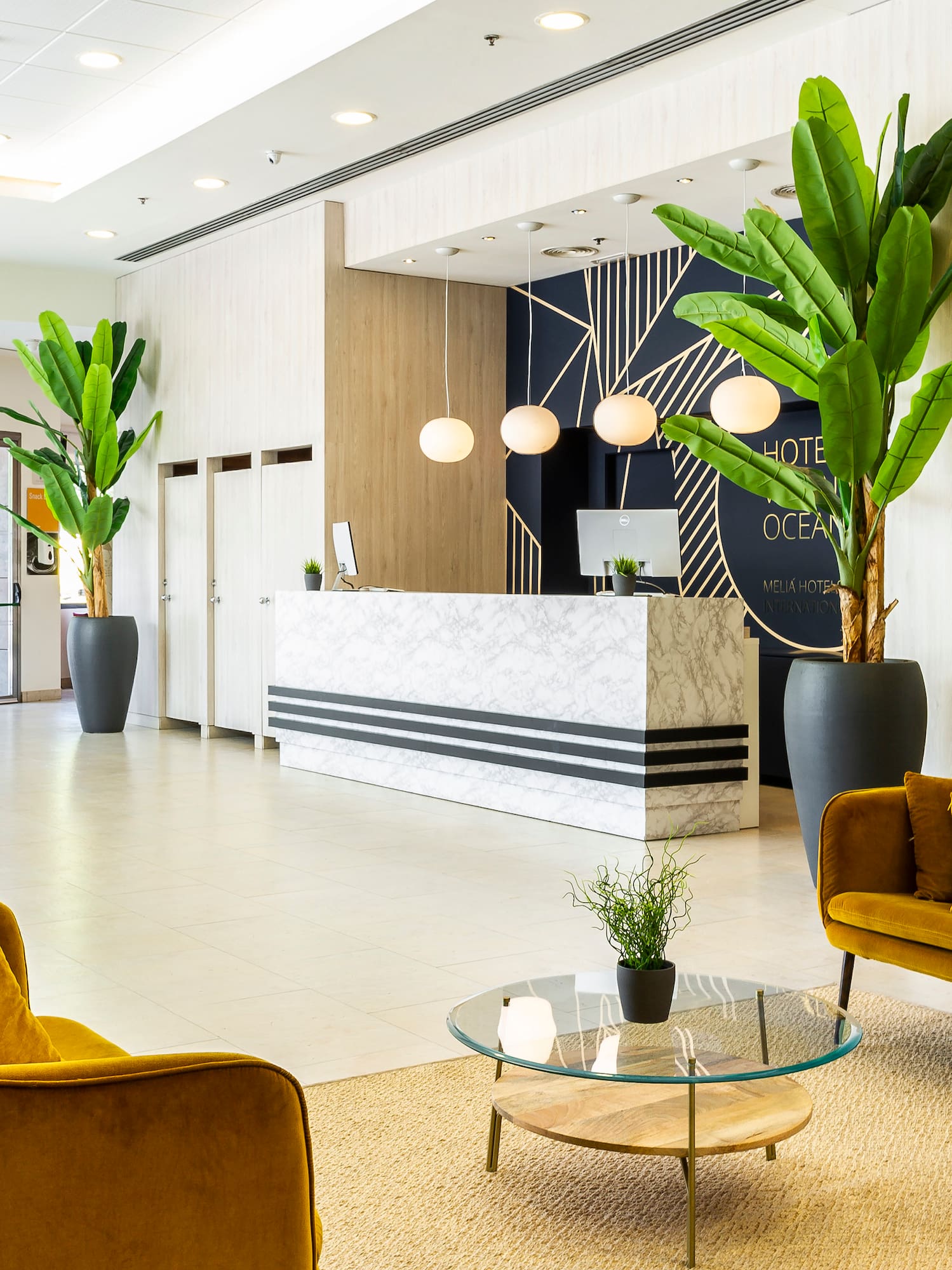 a lobby with a reception desk and chairs