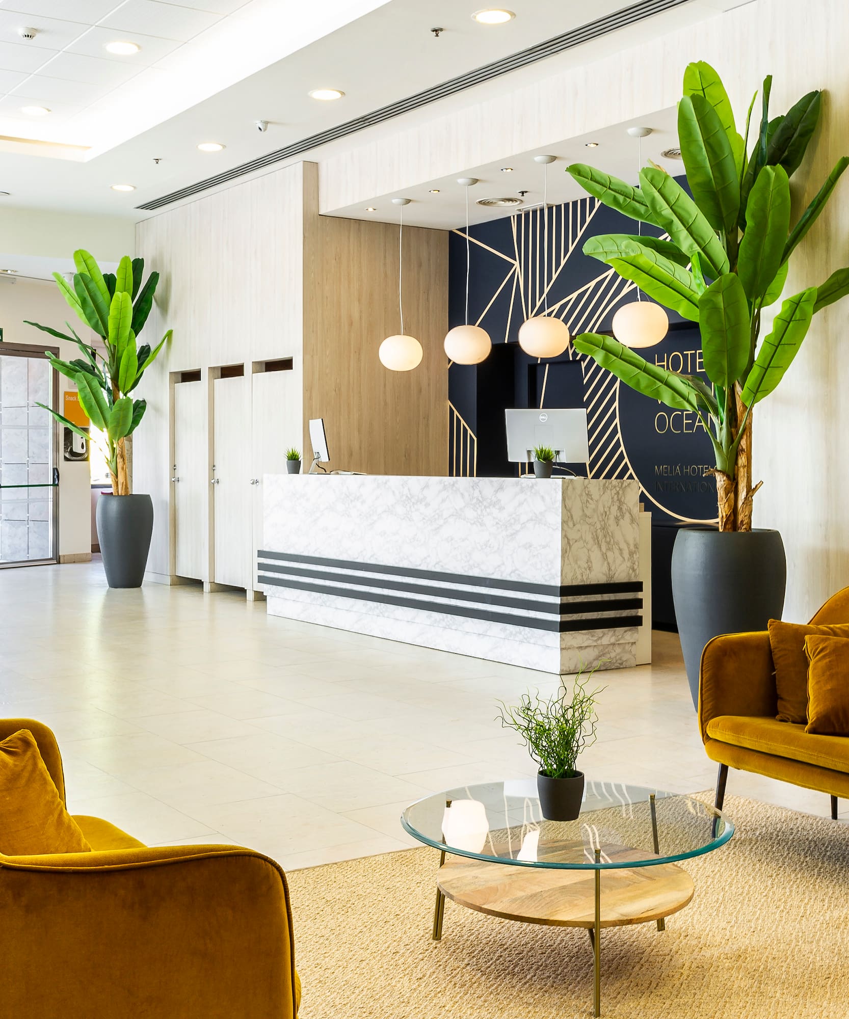 a lobby with a reception desk and chairs