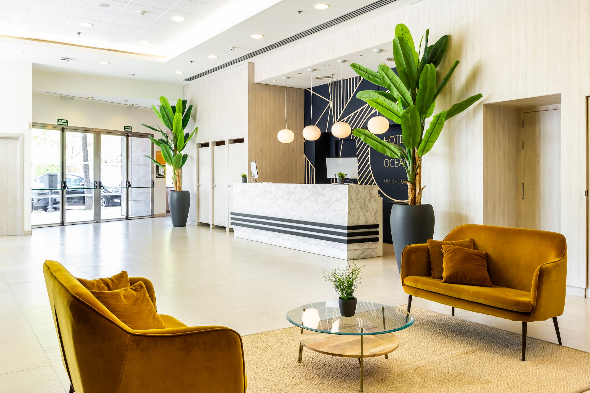 a lobby with a reception desk and chairs