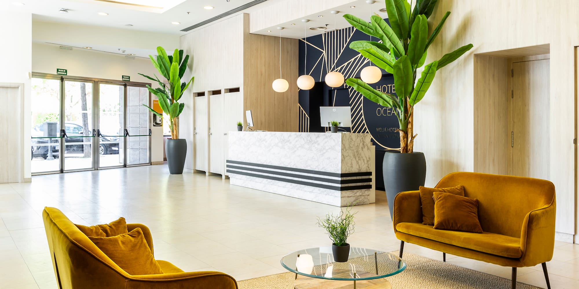a lobby with a reception desk and chairs