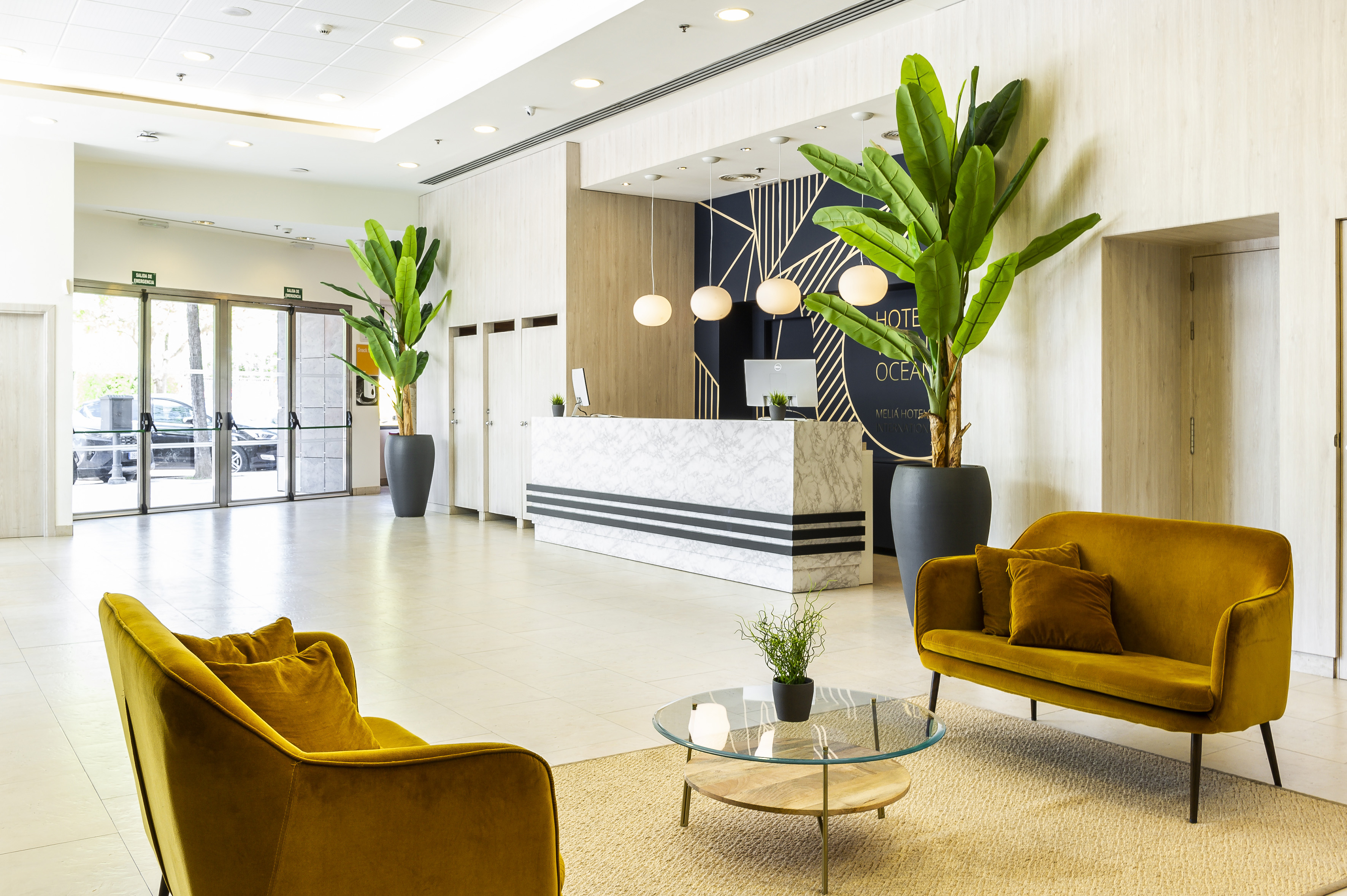 a lobby with a reception desk and chairs