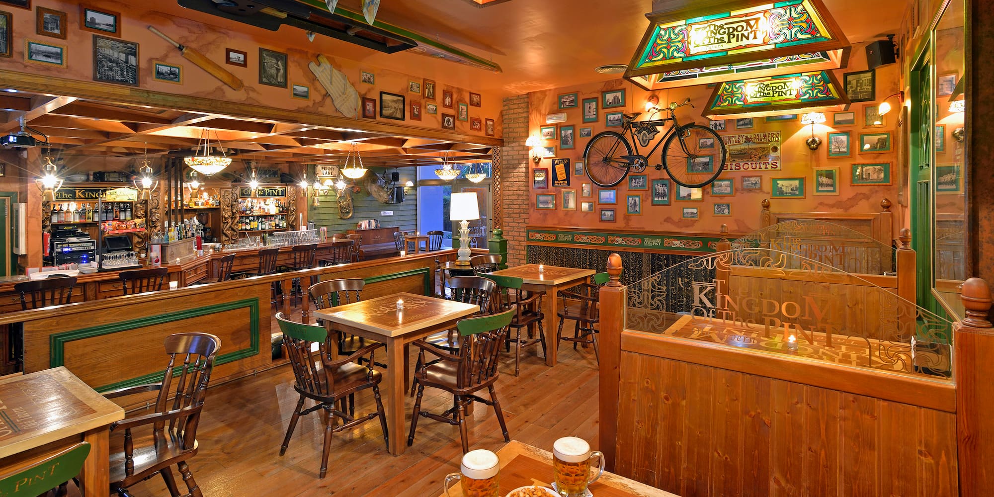 a room with tables and chairs and a bicycle on the wall