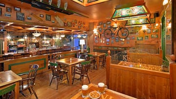 a room with tables and chairs and a bicycle on the wall