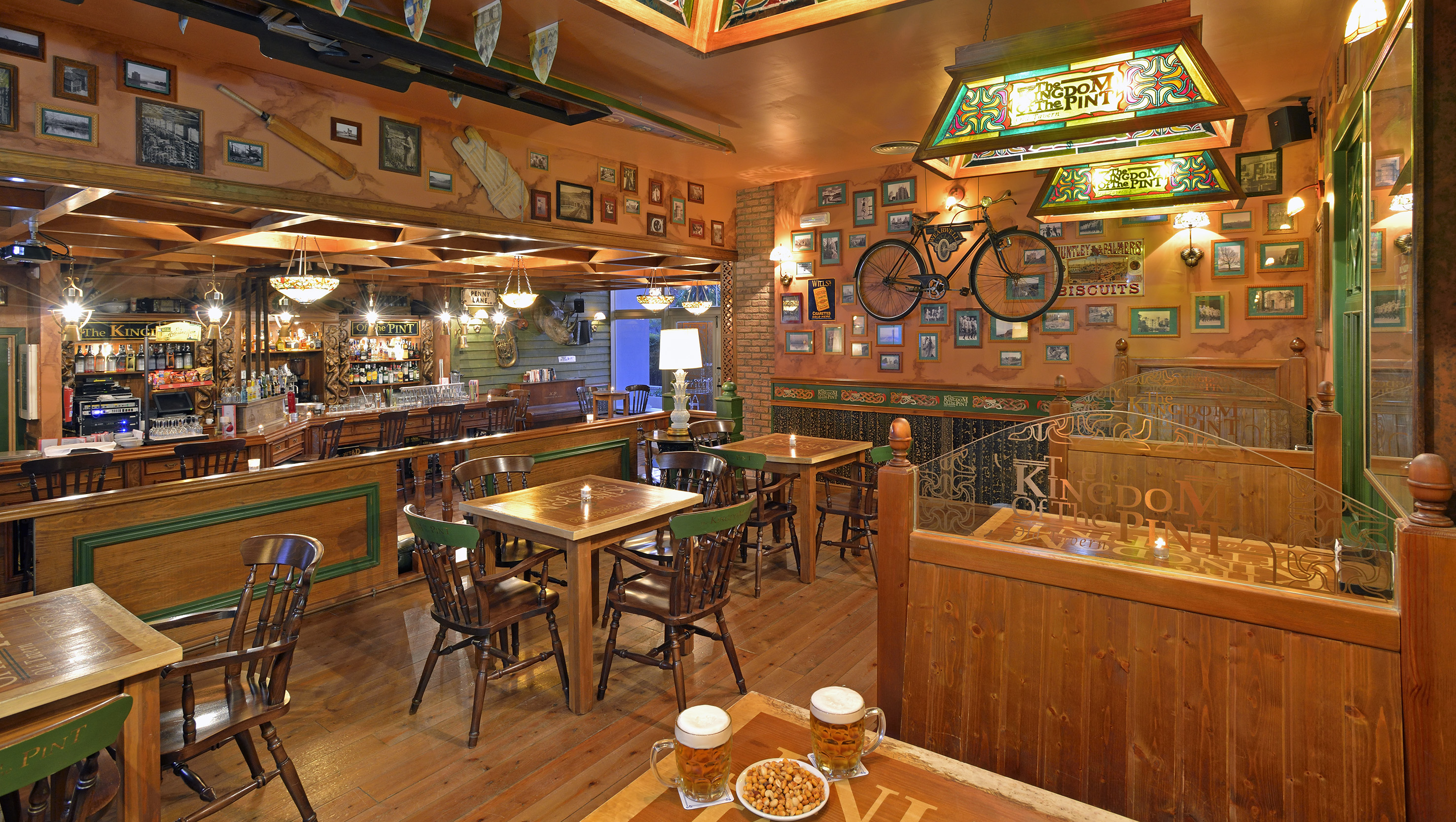 a room with tables and chairs and a bicycle on the wall
