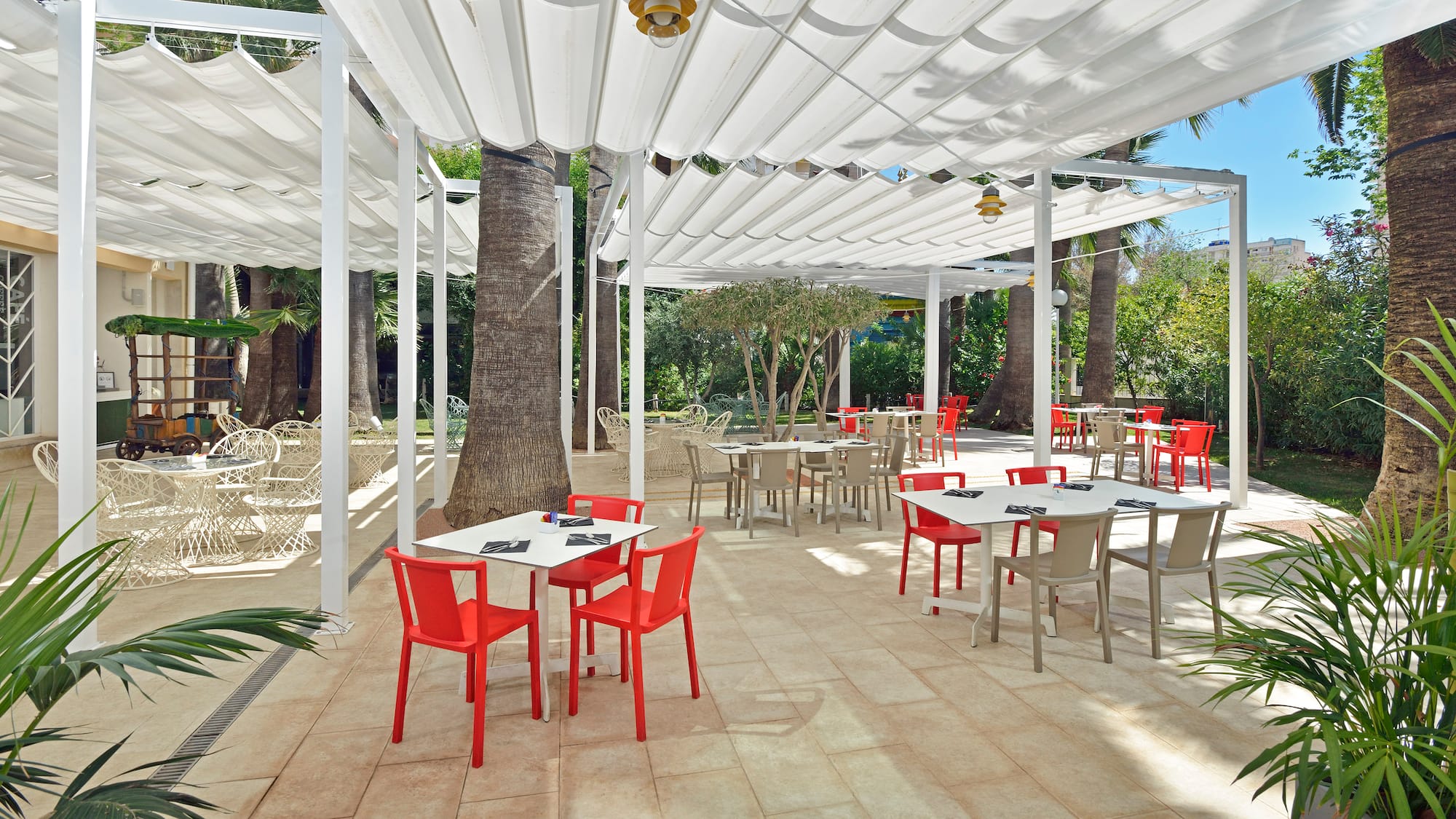 a white covered patio with tables and chairs